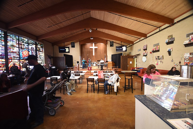 A sparse crowd relaxes inside The Salvation Army dining area Tuesday as winter temperatures soar beyond the norm in Chattanooga. The organization celebrates its 125th anniversary this year.