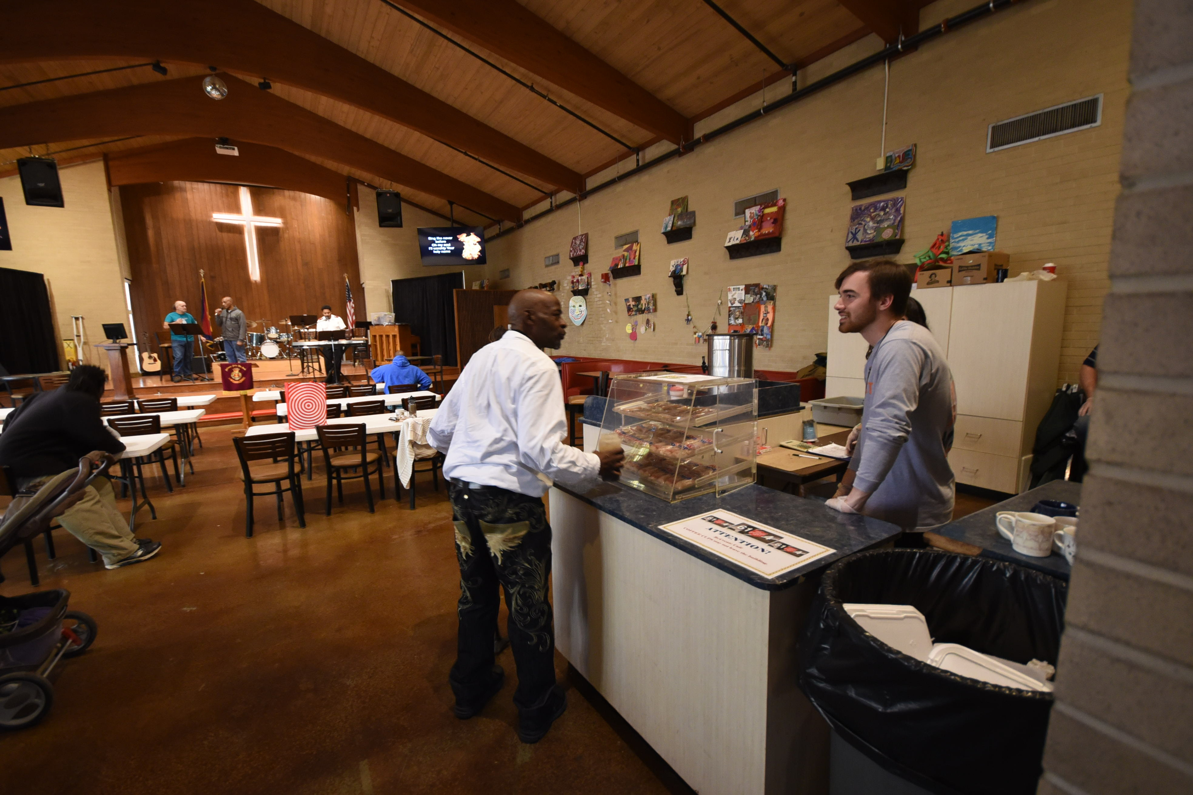 Lucas Dale, right, serves coffee to Christopher Thomas inside the Recreate Cafe at The Salvation Army as the organization celebrates its 125th anniversary in Chattanooga this year.