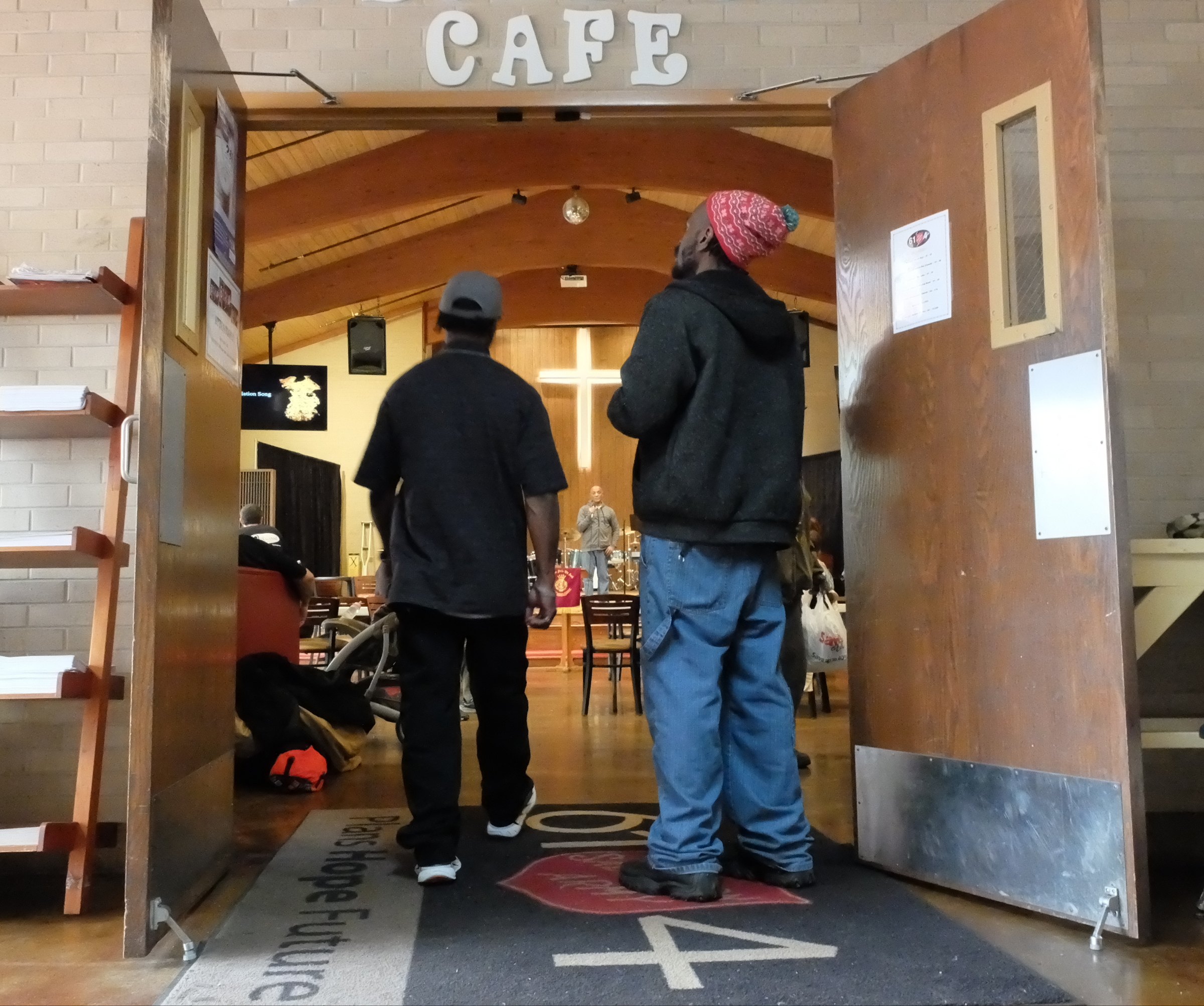 Two men enter the Recreate Cafe at the Salvation Army on Tuesday. The organization celebrates its 125th anniversary in Chattanooga this year.