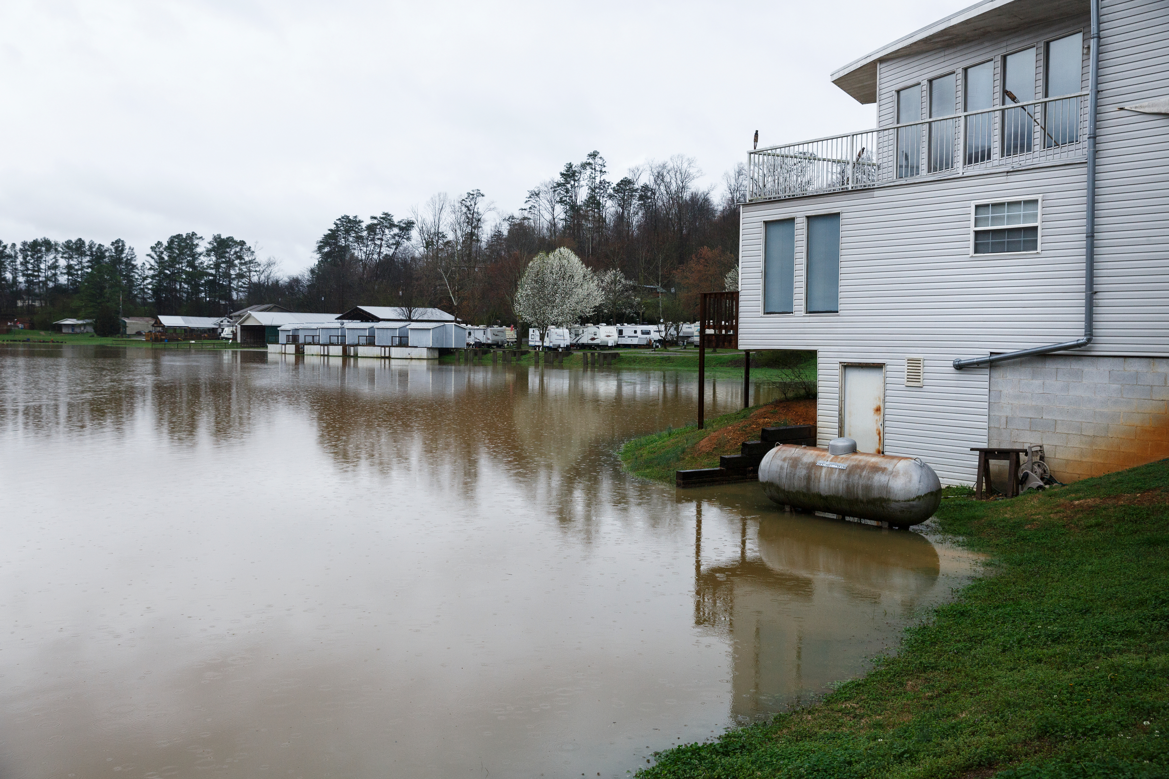 Floodwaters from Lookout Creak approach guest cabins in a camping center after heavy rainfall caused flooding throughout the region Thursday, March 1, 2018, in Wildwood, Ga.