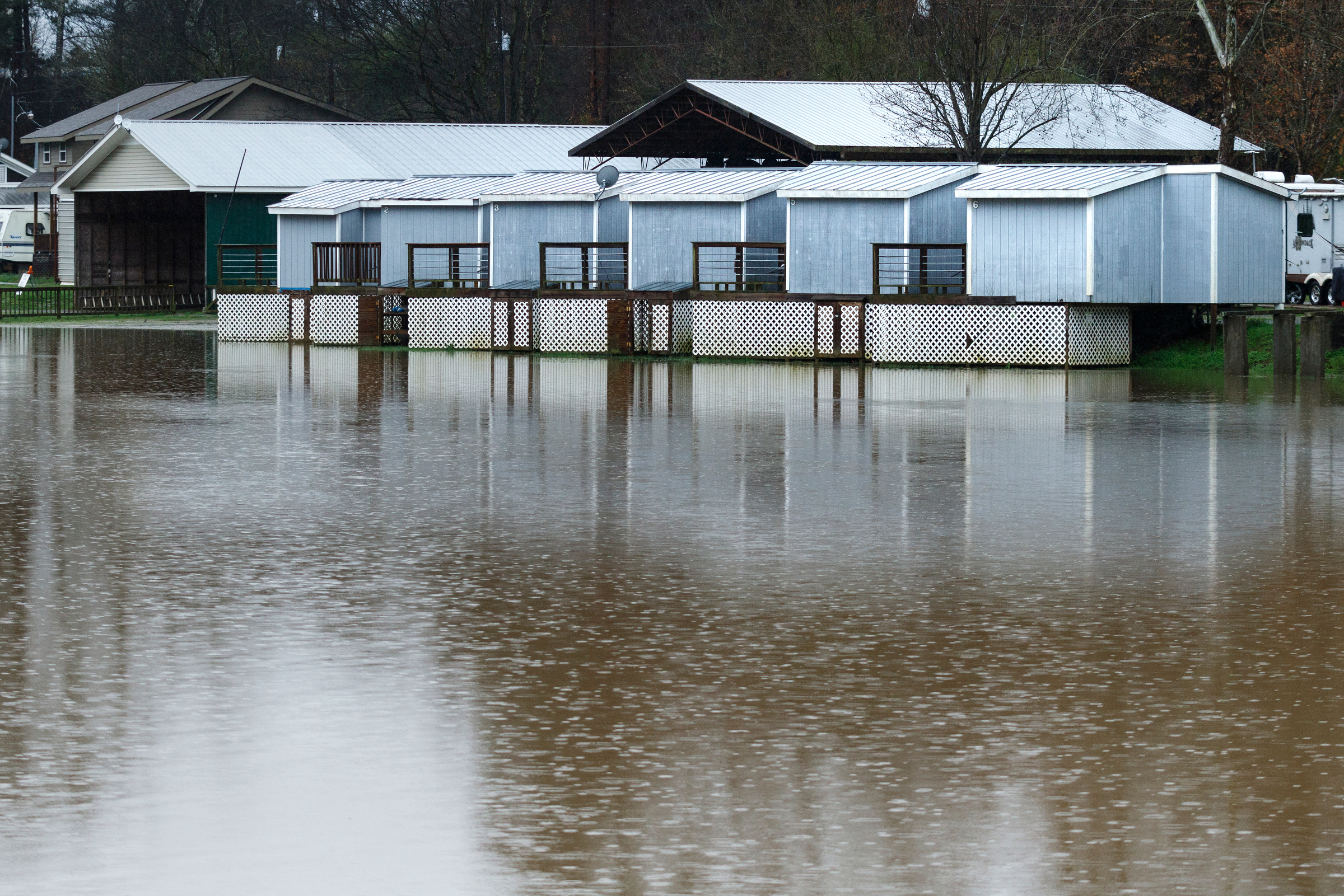Floodwaters from Lookout Creak approach guest cabins in a camping center after heavy rainfall caused flooding throughout the region Thursday, March 1, 2018, in Wildwood, Ga.