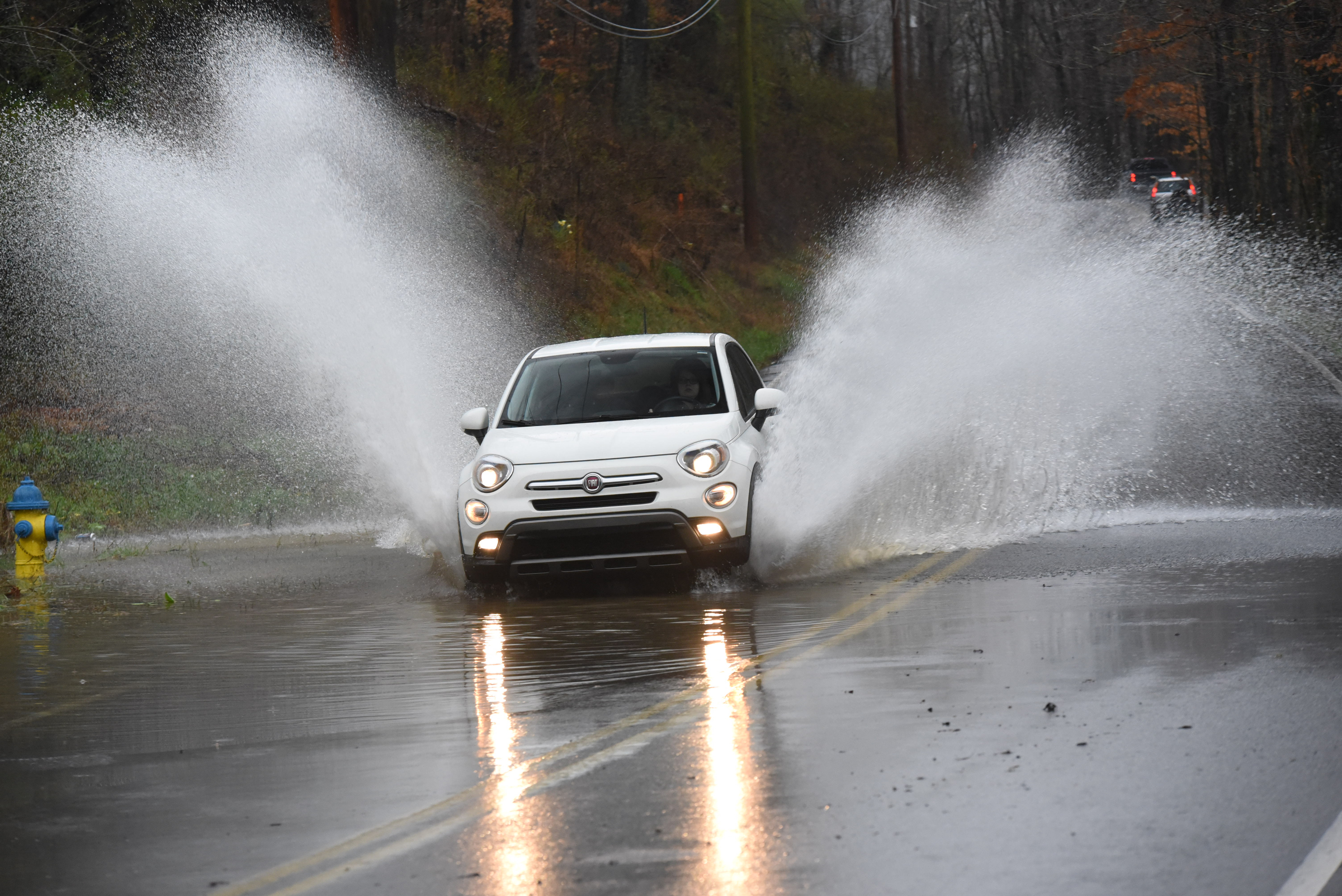 A compact car burst through standing water while eastbound on Boy Scout Road Thursday near the intersection of Sandswitch Road in Hixson.