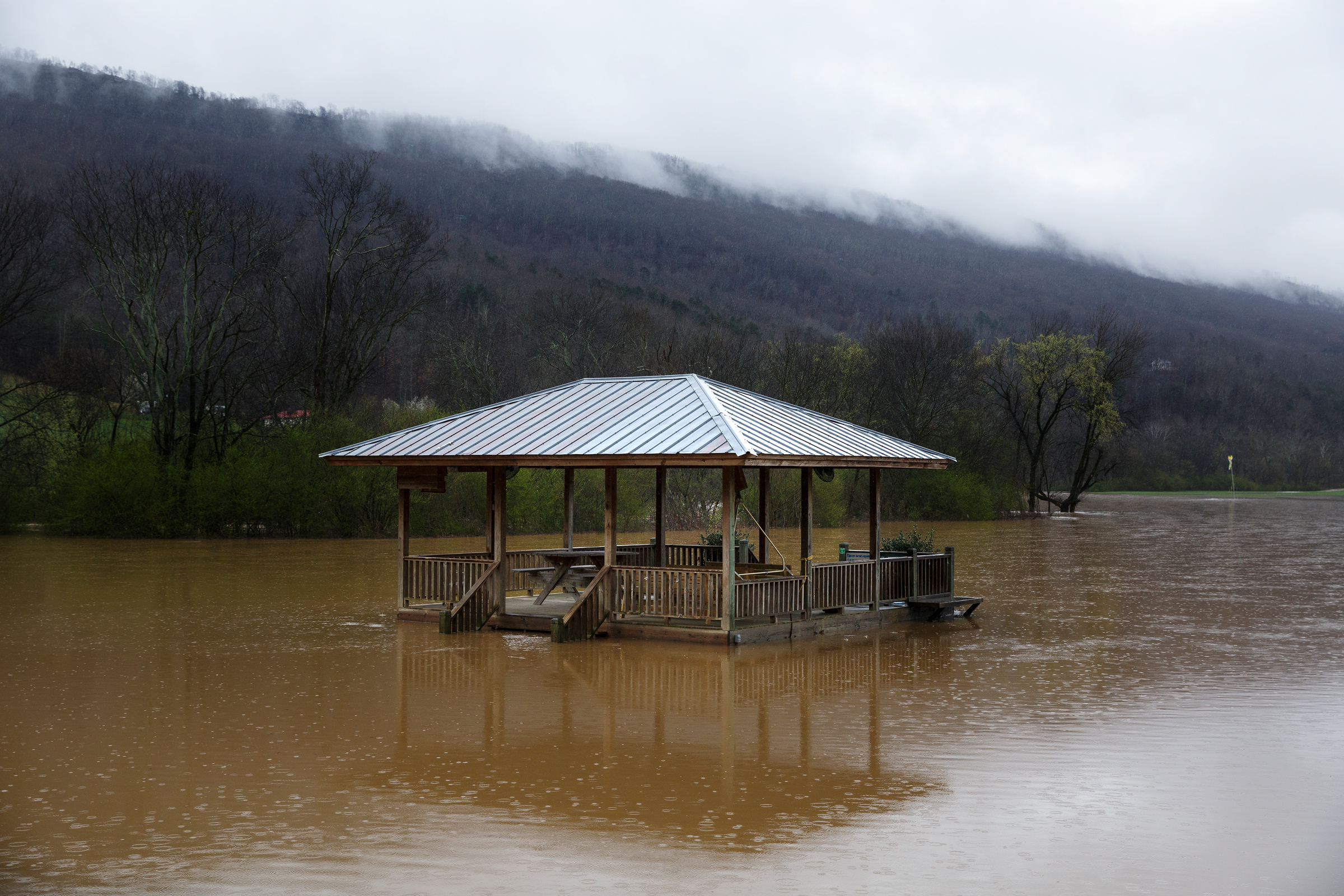 Floodwaters from Lookout Creek rise around a pavilion in a camping center at the foot of Lookout Mountain after heavy rainfall caused flooding throughout the region Thursday, March 1, 2018, in Wildwood, Ga.