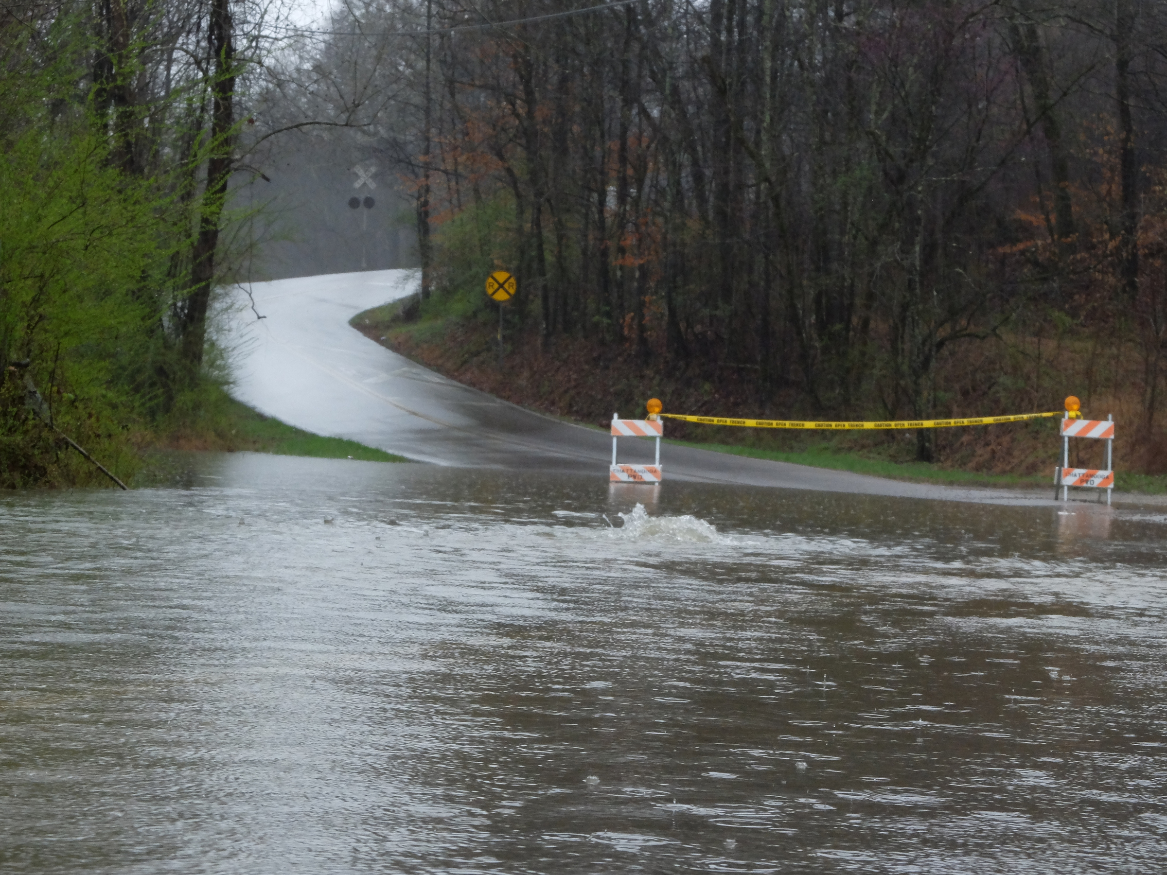 Water bubbles up from a manhole cover on Sandswitch Road Thursday near the intersection of Boy Scout Road in Hixson.