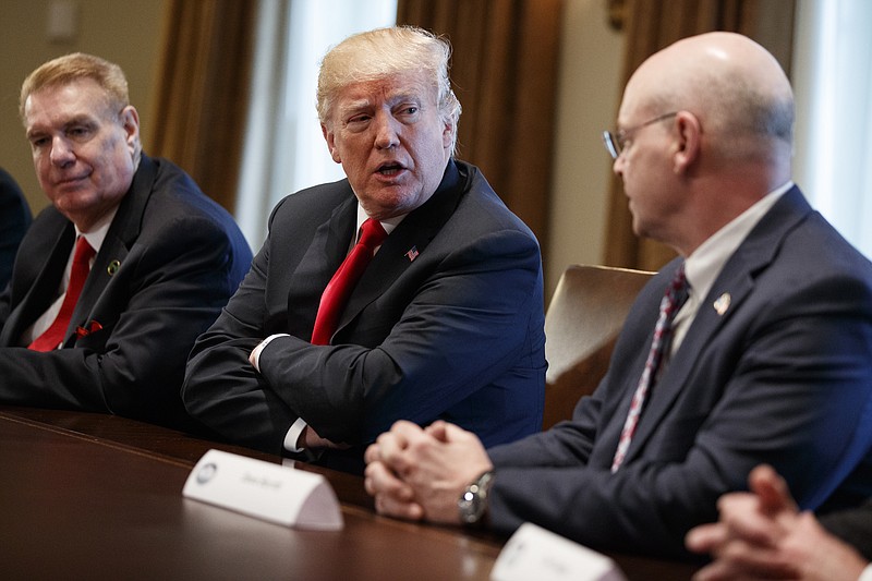 President Donald Trump speaks during a meeting with steel and aluminum executives in the Cabinet Room of the White House, Thursday, March 1, 2018, in Washington. From left, John Ferriola of Nucor, Trump, and Dave Burritt of U.S. Steel Corporation. (AP Photo/Evan Vucci)