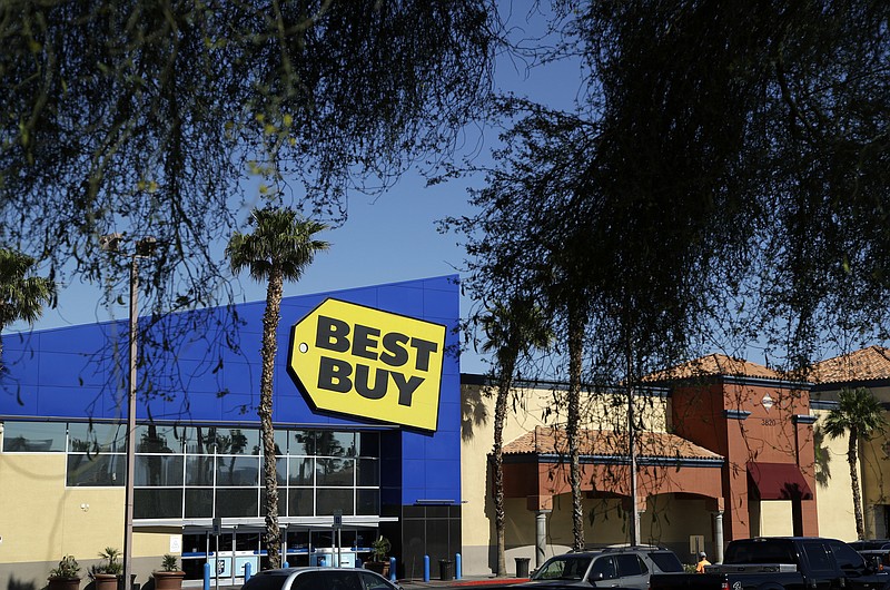 In this May 23, 2017, photo, cars are parked in front of a Best Buy in Las Vegas. Best Buy reports financial earns on Thursday, March 1, 2018. (AP Photo/John Locher)
