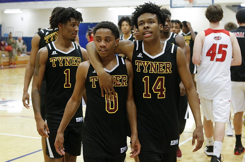 Tyner's Marquis Hinton (0) and Marcus Gladden (14) walk off the court after the Rams beat Signal Mountain 59-46 in the Region 3-AA title game Thursday night at Red Bank. Hinton scored 19 points off the bench.