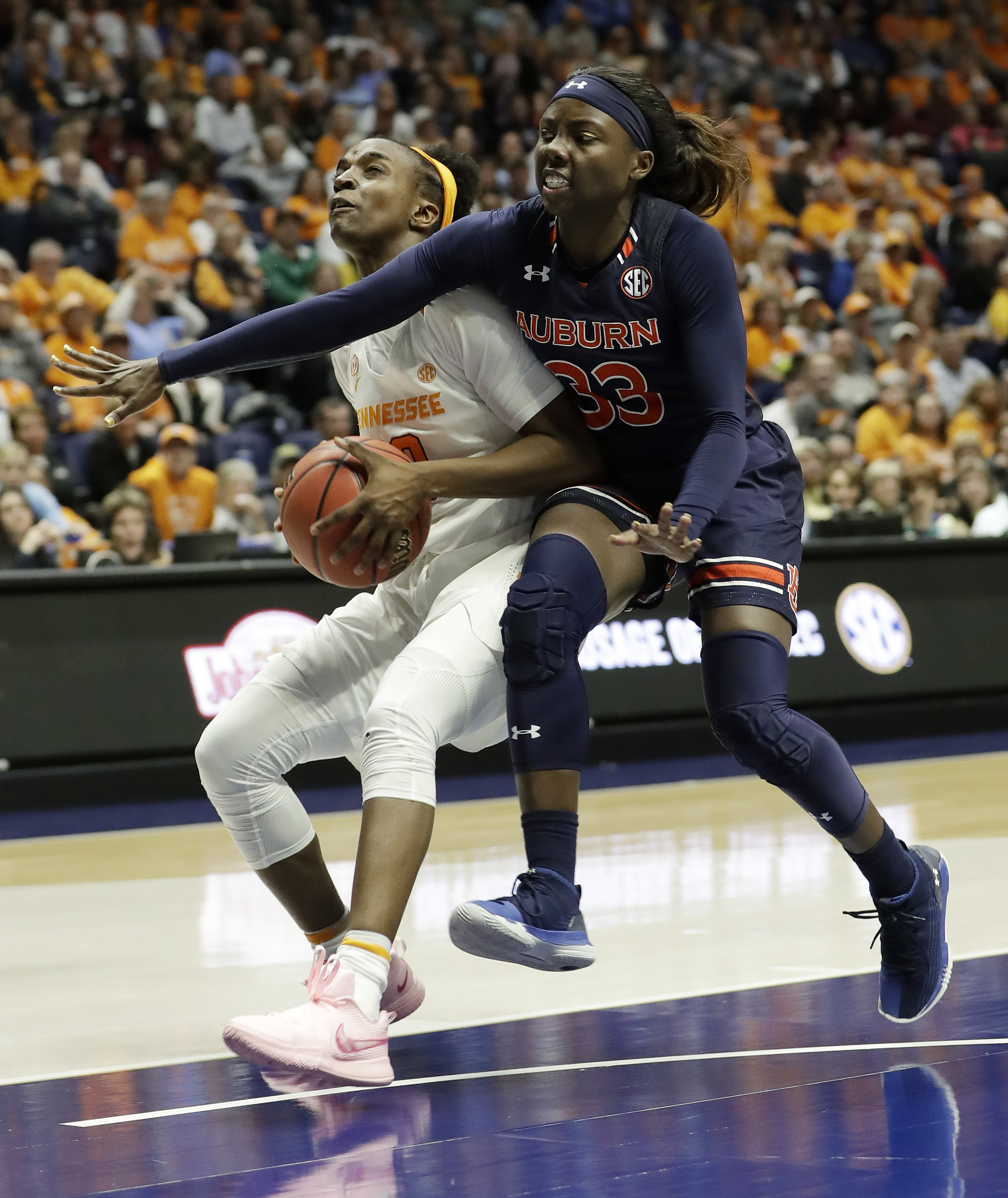 Tennessee guard Meme Jackson, left, drives to the basket and is fouled by Auburn guard Janiah McKay (33) in the second half of an NCAA college basketball game at the women's Southeastern Conference tournament Thursday, March 1, 2018, in Nashville, Tenn. (AP Photo/Mark Humphrey)