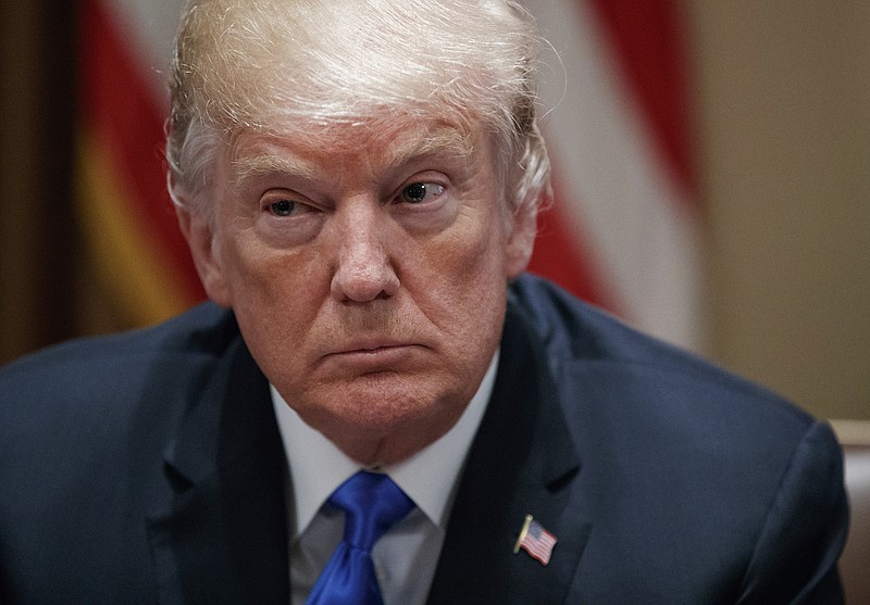 In this Feb. 28, 2018 photo, President Donald Trump pauses during a meeting in the Cabinet Room of the White House, in Washington, with members of congress to discuss school and community safety. 