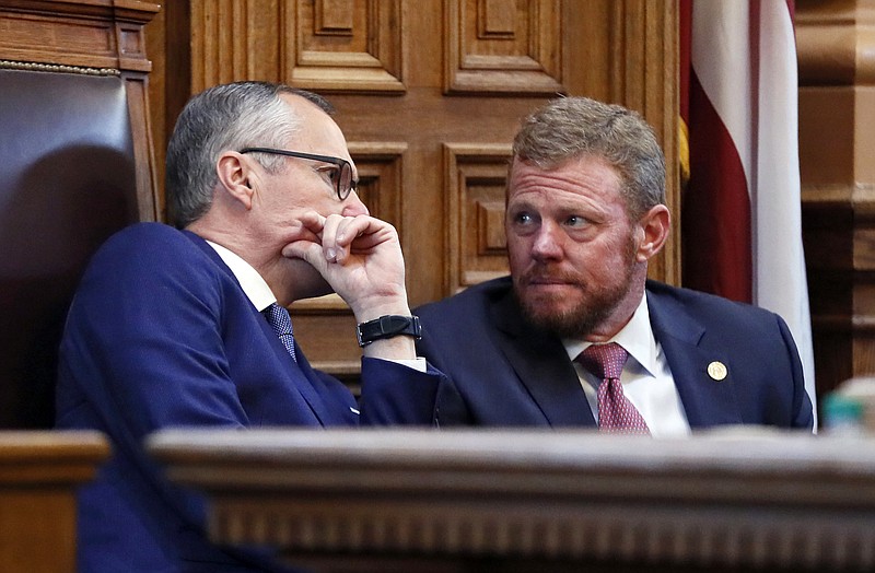 Lt. Gov. Casey Cagle and Gov. Deal's chief of staff Chris Riley confer in the senate before the senate went into recess and the Rules Committee stripped the Delta tax cut from legislation. 