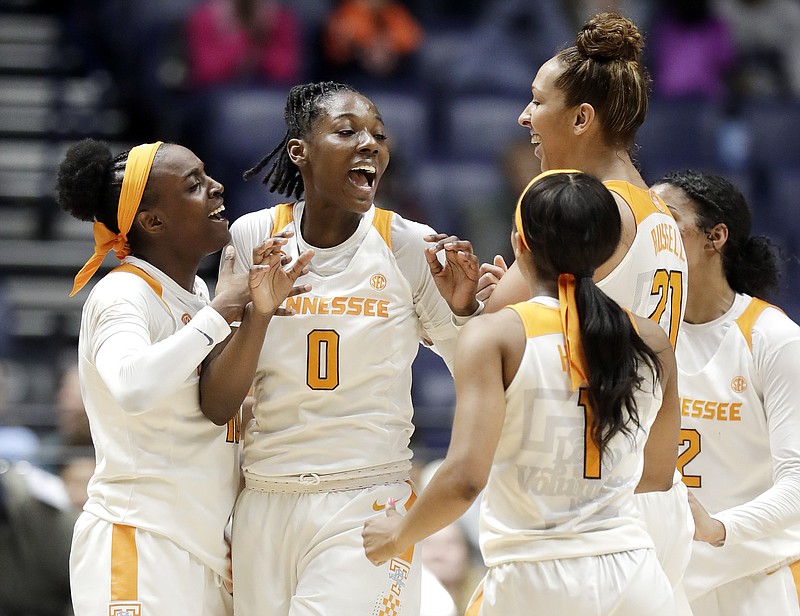 Tennessee's Rennia Davis (0) celebrates with teammates after shooting the winning three-point basket against Auburn with one second remaining in the fourth quarter of an NCAA college basketball game at the women's Southeastern Conference tournament Thursday, March 1, 2018, in Nashville, Tenn. (AP Photo/Mark Humphrey)