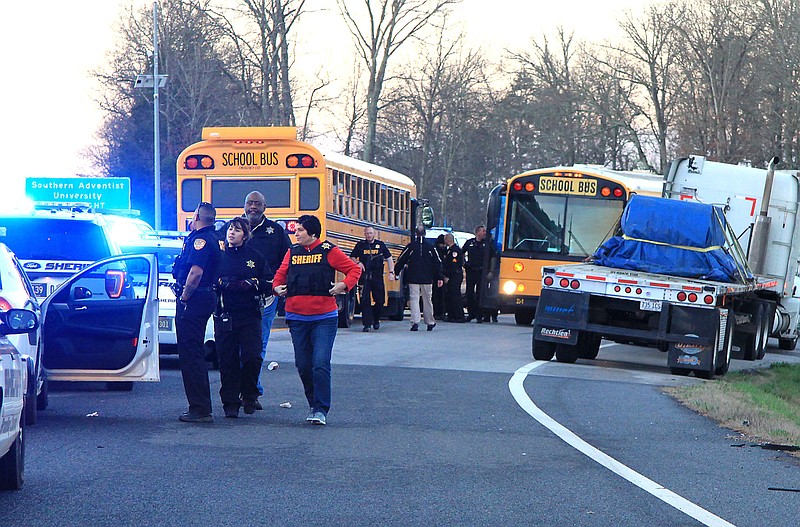 Bradley and Hamilton County deputies oversee the transfer of 60 convicted felons from the Bradley County Jail to a new ride after the the school bus they were riding in suffered a flat tire on I-75 near Ooltewah around 6 a.m. Friday. The inmates were being driven to the state prison in Bledsoe County to ease crowding in the Bradley jail.