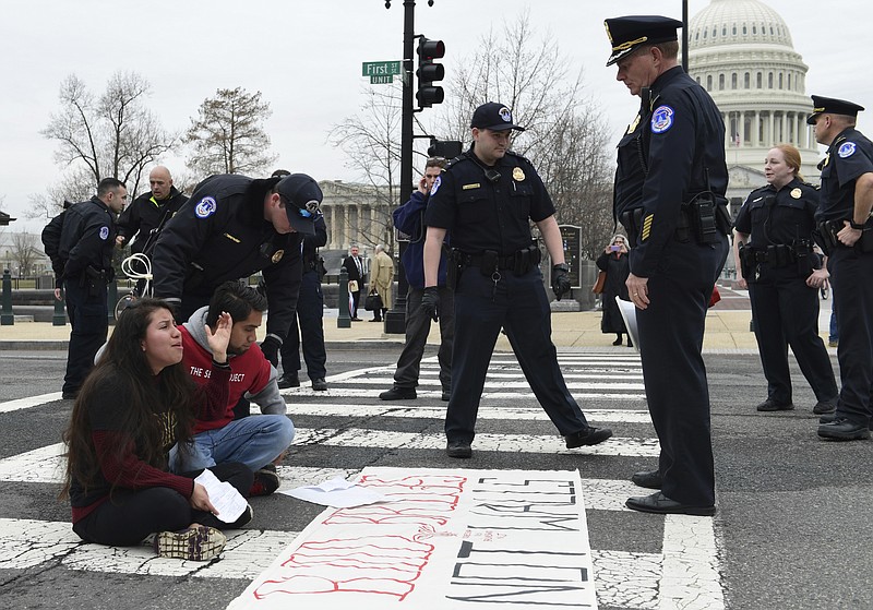 Protesters are arrested as they block the streets near the Capitol and the Supreme Court in Washington, Thursday, March 1, 2018. It's taken just two weeks for Washington's battle over helping young immigrants to fade from blistering to back-burner. Congress now seems likely to do little or nothing this election year on an effort that's been eclipsed by Congress' new focus on guns, bloodied by Senate defeats and relegated to B-level urgency by a Supreme Court ruling. (AP Photo/Susan Walsh)