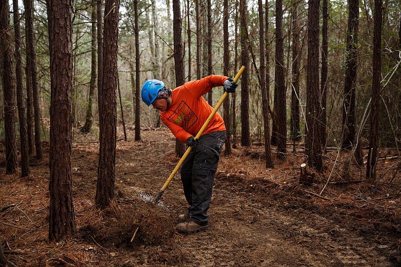 Pablo Flores with Trail Dynamics uses a tool to edge a path while building a new horse trail at Enterprise South Nature Park on Tuesday, Feb. 20, 2018, in Chattanooga, Tenn. The trail is scheduled to open in the spring.