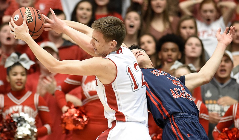 Baylor's Boris Ristanovic (12) pulls a rebound away from Brentwood's Devyn Curtis (35).  The Baylor Red Raiders faced the Brentwood Academy Eagles in the Division II Class AA TSSAA boys' basketball championship at The Allen Center on the campus of David Lipscomb University on March 3, 2018