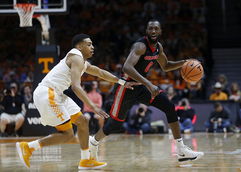 Georgia guard William Jackson II (0) is defended by Tennessee guard James Daniel III during the first half of an NCAA college basketball game Saturday, March 3, 2018, in Knoxville, Tenn. (AP Photo/Crystal LoGiudice)