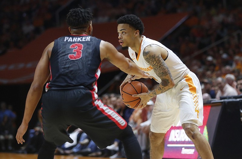 Tennessee's Lamonte Turner is guarded by Georgia's Juwan Parker during Saturday's game in Knoxville. Turner scored nine points, all of them in crucial moments, as the Vols won 66-61 to earn a share of the SEC regular-season title.