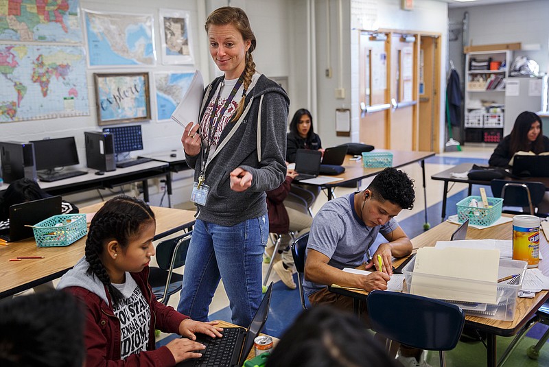 ESOL teacher Ellen Smith works with students Paola Ramirez, left, and Amilcar during a directed studies period at Howard School on Friday, March 2, 2018, in Chattanooga, Tenn. Smith and fellow Howard ESOL teacher Andrea Dyer are taking 18 of their students to Washington D.C. for their senior year.