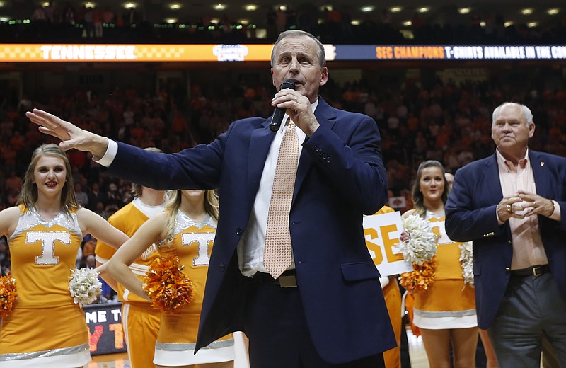 Tennessee men's basketball coach Rick Barnes talks to fans as athletic director Phillip Fulmer, right, looks on after the Vols beat Georgia on Saturday in Knoxville to earn a share of the SEC's regular-season championship.