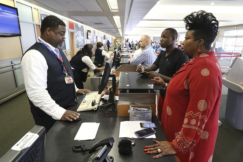 Delta associate Sheldon Posey, left, talks with Sheila Simpson and Raekwon Bunion at Chattanooga Metropolitan Airport.