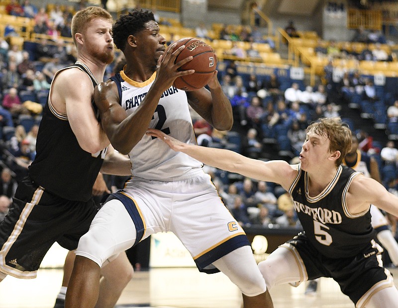 UTC's Joshua Phillips (2) is double-teamed by Wofford's Matthew Pegram (50) and Storm Murphy (5).  The Wofford Terriers visited the Chattanooga Mocs in Southern Conference basketball action at McKenzie Arena on February 17, 2018.  