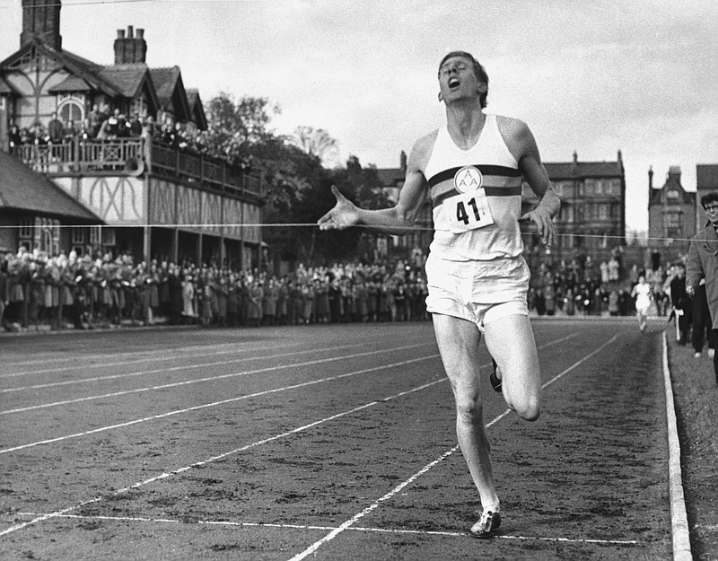 In this May 6, 1954, file photo, British athlete Roger Bannister breaks the tape to become the first man ever to break the four minute barrier in the mile at Iffly Field in Oxford, England. Bannister, the first runner to break the 4-minute barrier in the mile, has died. He was 88. Bannister's family said in a statement that he died peacefully on Saturday, March 3, 2018, in Oxford "surrounded by his family who were as loved by him, as he was loved by them." (AP Photo/File)