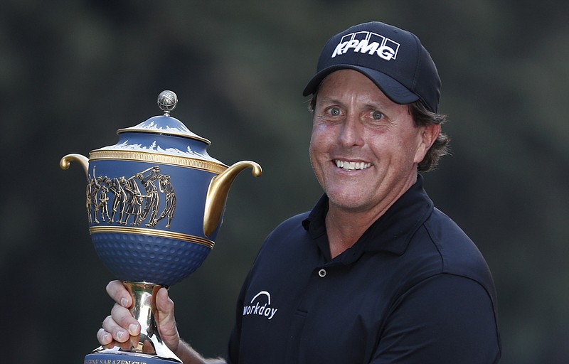 Phil Mickelson, of the U.S., poses with his Mexico Championship trophy at the Chapultepec Golf Club in Mexico City, Sunday, March 4, 2018. (AP Photo/Eduardo Verdugo)