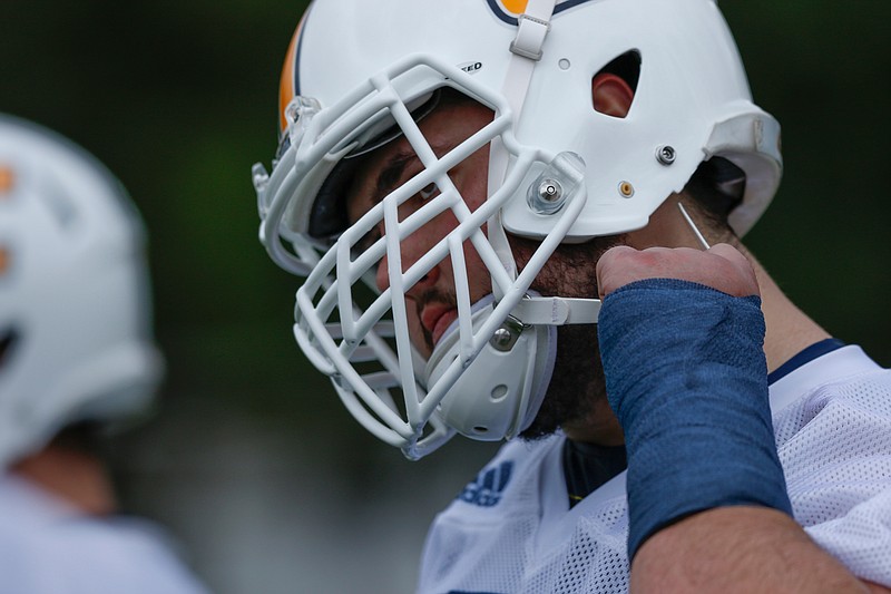 Offensive lineman Harrison Moon removes his helmet during the UTC football team's first spring practice at Scrappy Moore Field on Saturday, Feb. 24, 2018, in Chattanooga, Tenn. 