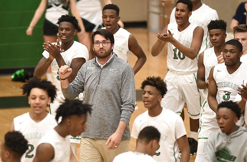Staff Photo by Robin Rudd East Hamilton head coach Zach Roddenberry pumps his fist as his team comes off the floor at a timeout. The Riverdale Warriors visited the East Hamilton Hurricanes in a TSSAA sectional game on March 5, 2018