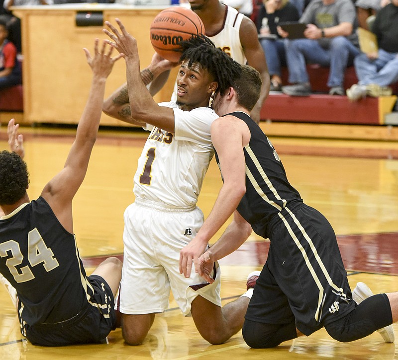 Tyner's Jeremy Elsotn (1) gains control from Upperman's Isaiah Allen (24) and Jaydon Kanipe in a scrapping first half battle at Tyner Monday in the Class AA sub-state game.
