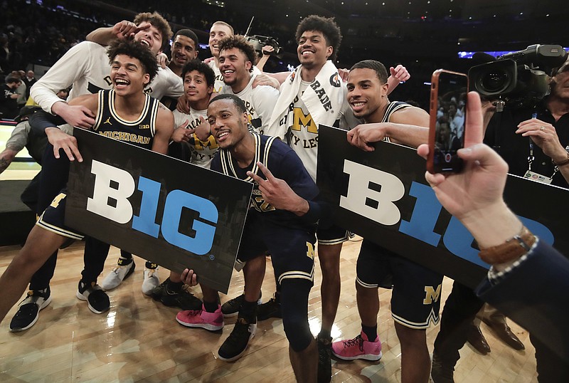 Michigan players celebrate after beating Purdue 75-66 to win the NCAA Big Ten Conference tournament championship college basketball game, Sunday, March 4, 2018, in New York. (AP Photo/Julie Jacobson)
