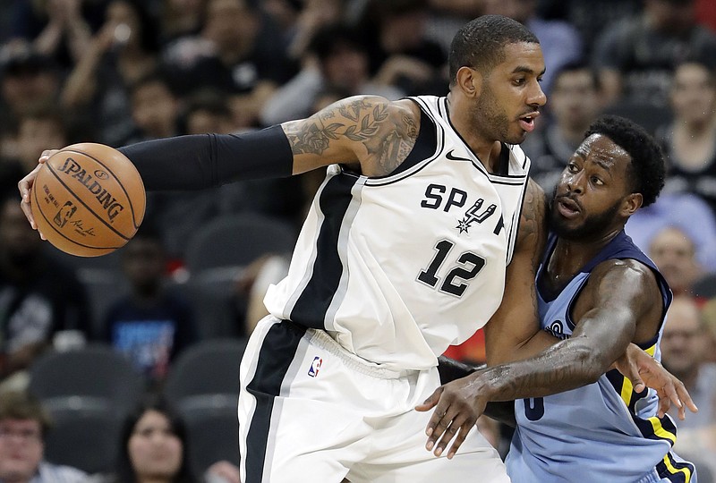 San Antonio Spurs forward LaMarcus Aldridge (12) is pressured by Memphis Grizzlies forward JaMychal Green, right, during the first half of an NBA basketball game, Monday, March 5, 2018, in San Antonio. (AP Photo/Eric Gay)