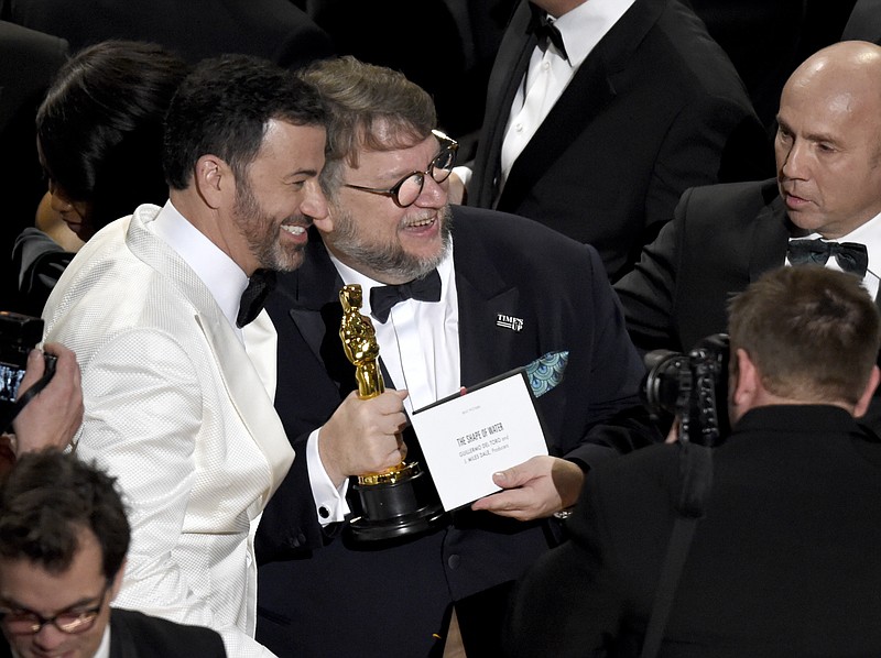 Academy Awards host Jimmy Kimmel, left, congratulates director Guillermo del Toro after the latter's movie "The Shape of Water" was named Best Picture at Sunday's Oscars ceremony in Los Angeles.