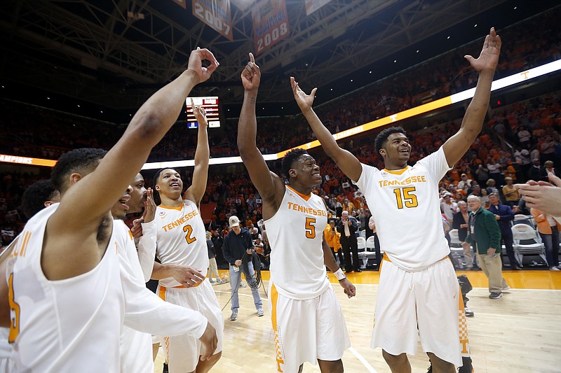 Tennessee forward Derrick Walker (15), forward Admiral Schofield (5), forward Grant Williams (2) and guard James Daniel III, left, celebrate the team's 66-61 win over Georgia during an NCAA college basketball game Saturday, March 3, 2018, in Knoxville, Tenn. (AP Photo/Crystal LoGiudice)

