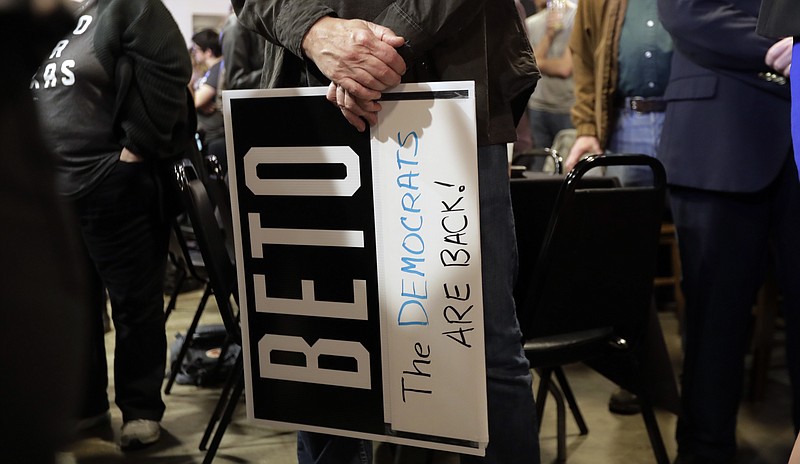 A supporter of senate hopeful Beto O'Rourke holds a sign during a Democratic watch party following the Texas primary election, Tuesday, March 6, 2018, in Austin, Texas. (AP Photo/Eric Gay)