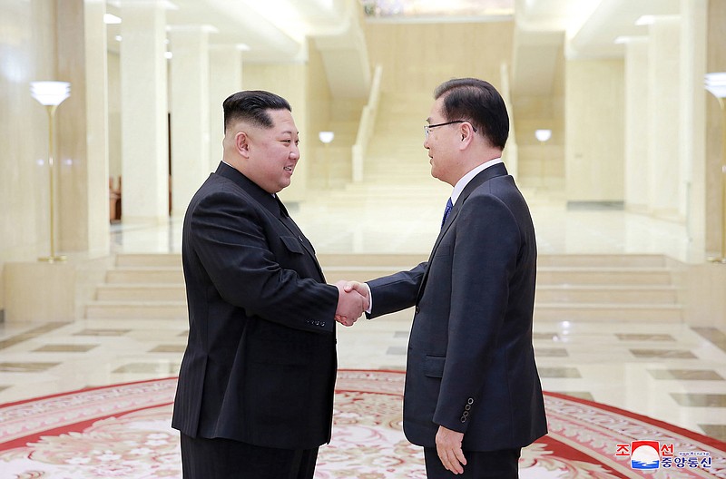 North Korean leader Kim Jong Un, left, shakes hands with South Korean National Security Director Chung Eui-yong in Pyongyang, North Korea, after it was reported Chung gave Kim a letter from South Korea President Moon Jae-in.