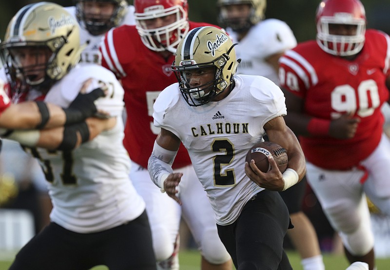 Olico Dennis (2) picks his way through the defense during Calhoun's game at Dalton in August 2016. The former Calhoun running back injured his knee that season, ending his prep career, but he has signed with Shorter University.