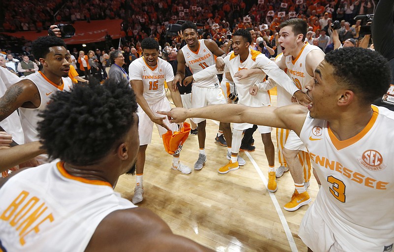 Tennessee's James Daniel III (3) and teammates celebrate defeating Georgia 66-61 for a share of the SEC regular-season championship last Saturday in Knoxville. The Vols open play in the SEC tournament tonight in St. Louis.