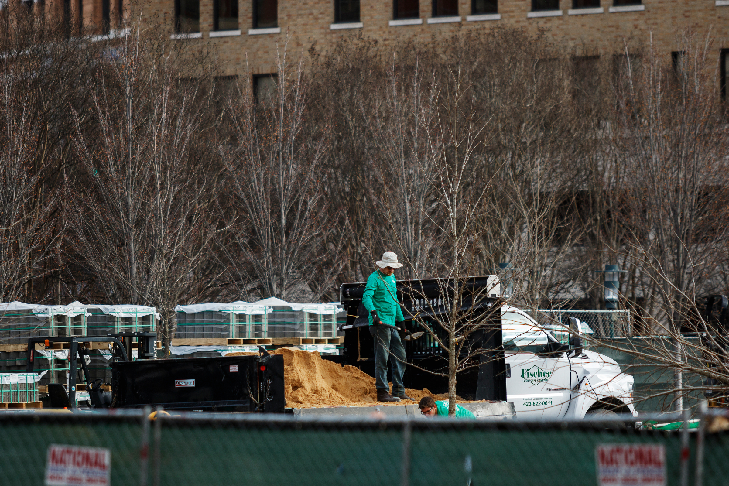 A worker stands in the bed of a truck while adding sediment to Miller Park on Thursday, Feb. 22, 2018, in Chattanooga, Tenn. Martin Luther King Boulevard will remain closed at its intersection with the park until March 13 after the discovery of an unexpectedly high water main delayed the road's resurfacing by about three weeks, according to Chattanooga Department of Public Works administrator Justin Holland.