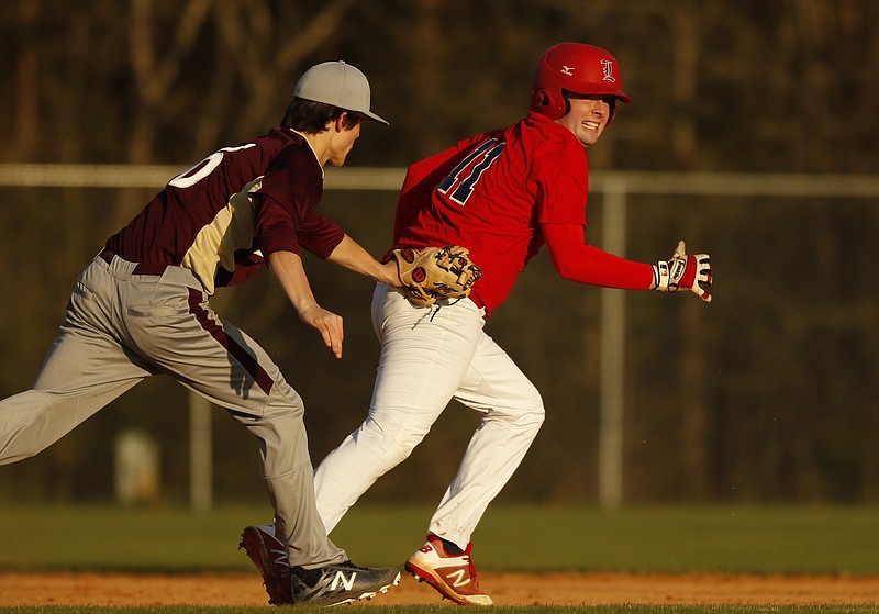 Dade County shortstop Seth Swader runs down LFO runner Matthew Trusley in the base path after he tried to sneak an extra base out of a walk during their prep baseball game at Dade County High School on Thursday, March 8, 2018, in Trenton, Ga. 