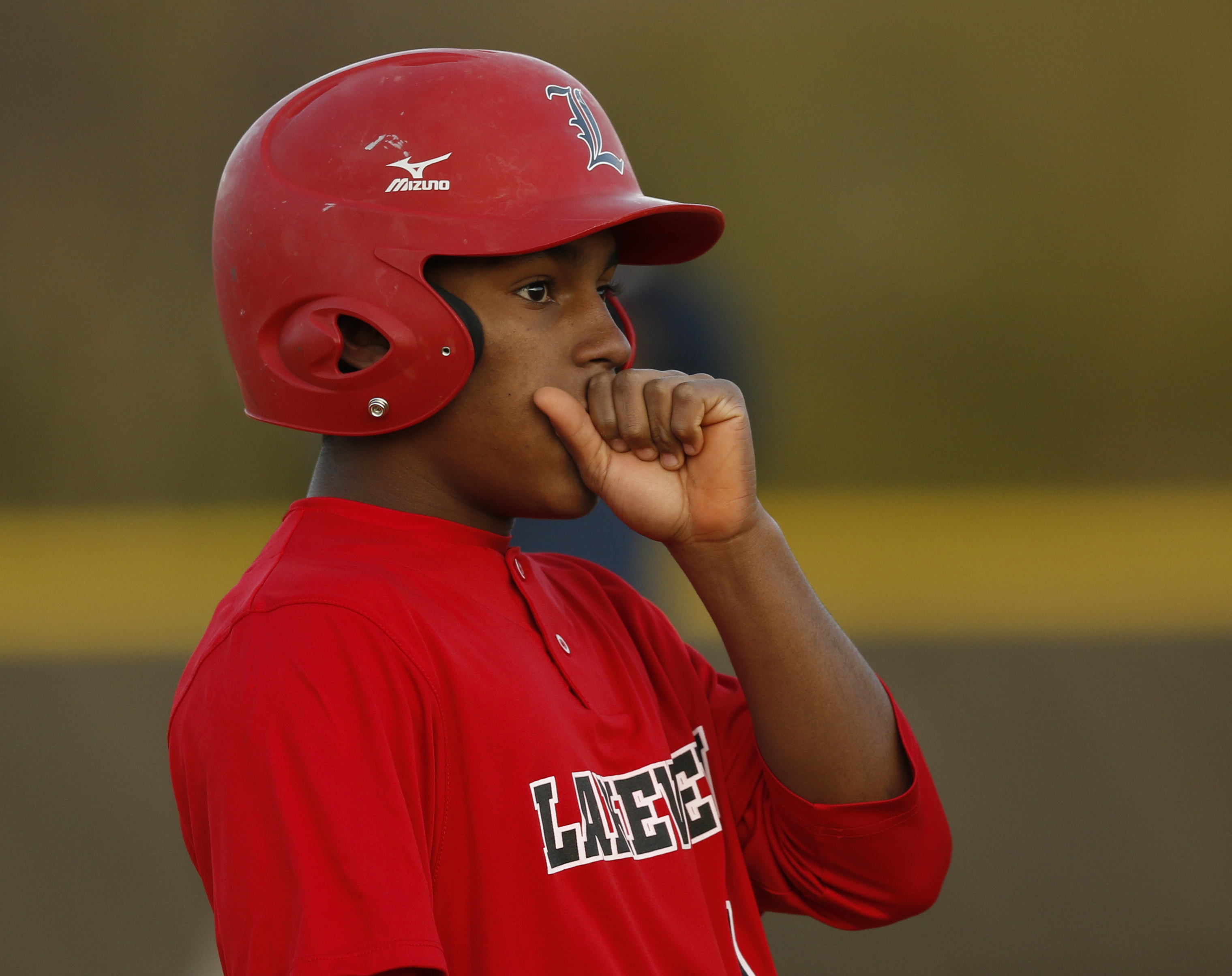 LFO runner Giovanni Barroso warms his hand with his breath during their prep baseball game at Dade County High School on Thursday, March 8, 2018, in Trenton, Ga.