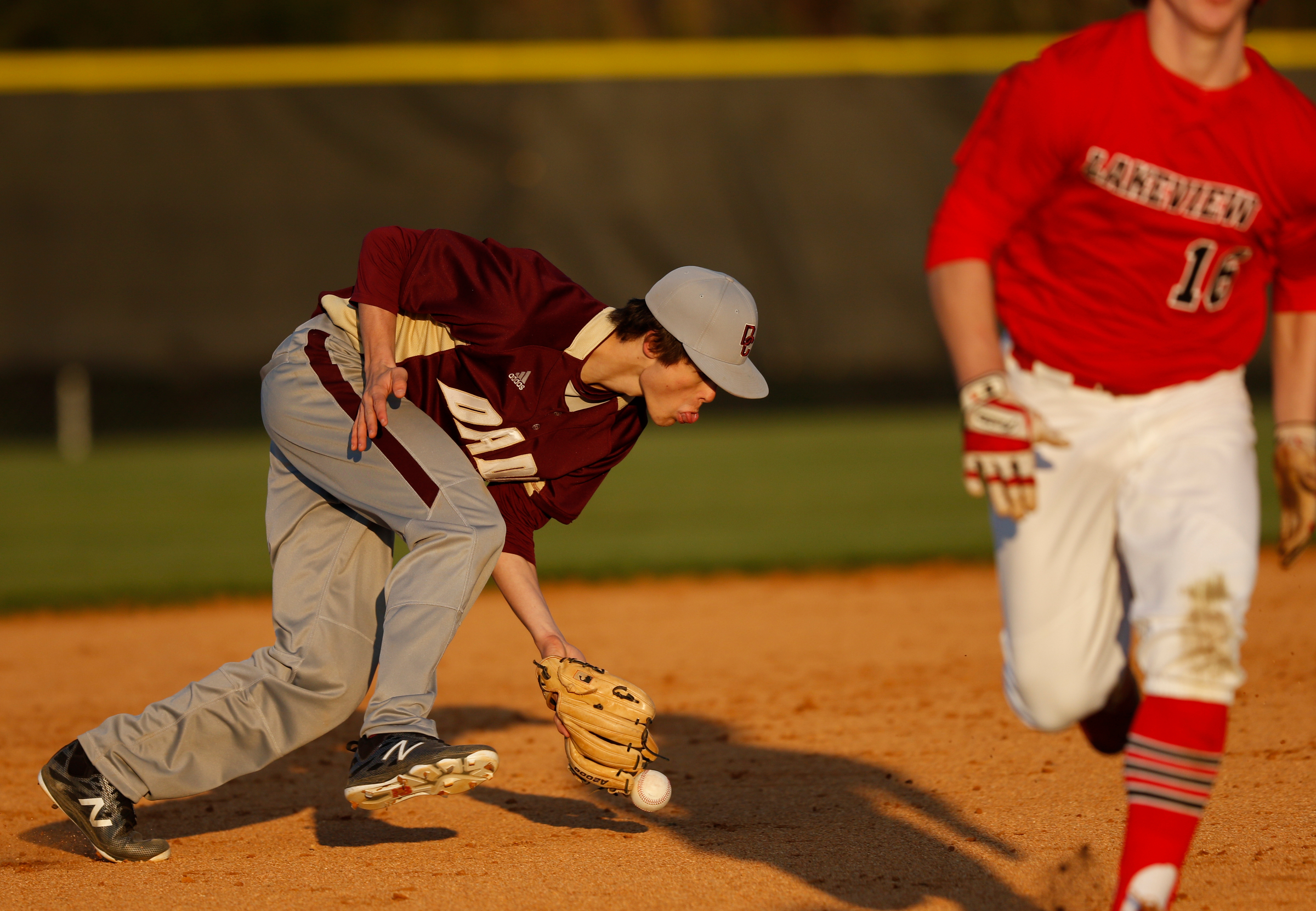 LFO runner Jacob Flanagan runs for third as Dade County shortstop Seth Swader misfields a grounder during their prep baseball game at Dade County High School on Thursday, March 8, 2018, in Trenton, Ga.