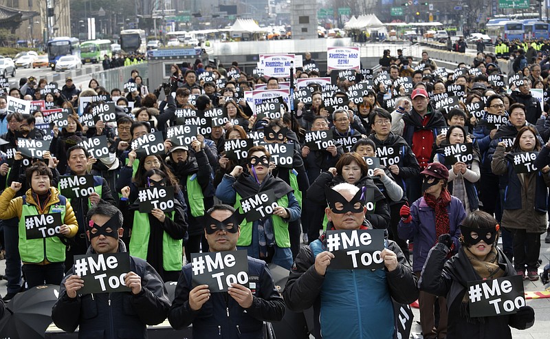 Demonstrators supporting the MeToo movement wearing black stage a rally to mark the International Women's Day in Seoul, South Korea, Thursday, March 8, 2018. (AP Photo/Ahn Young-joon)