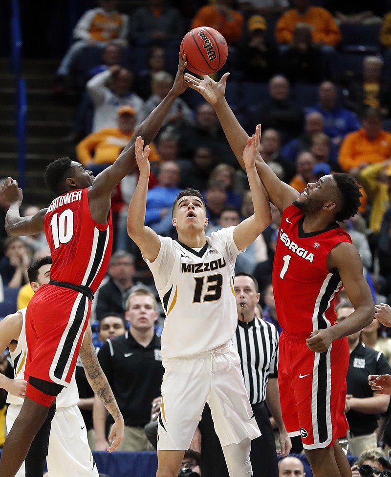 Missouri's Michael Porter Jr. (13) reaches for a rebound between Georgia's Teshaun Hightower (10) and Yante Maten (1) during the second half in an NCAA college basketball game at the Southeastern Conference tournament Thursday, March 8, 2018, in St. Louis. (AP Photo/Jeff Roberson)