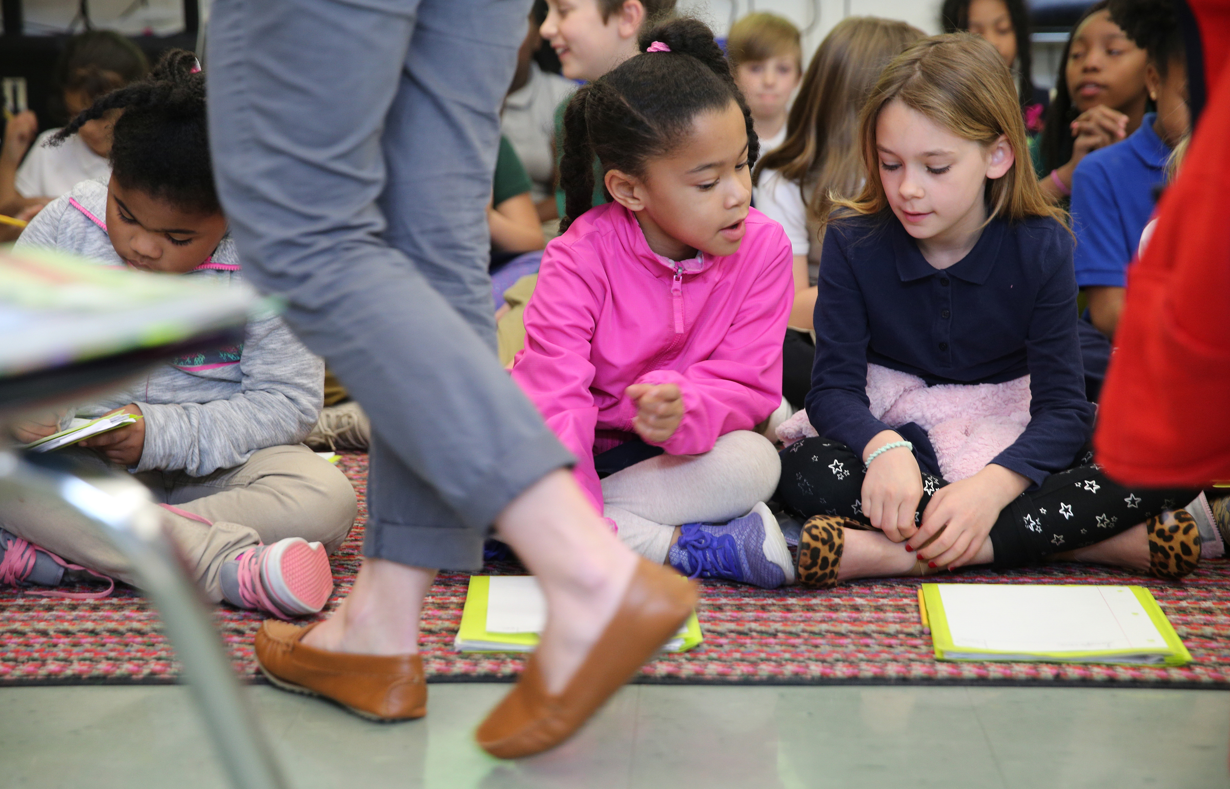 Symora Caslin, 9, Kyi Brown, 8, and Elizabeth Smith, 9, talk amongst themselves while learning about landforms from a University of Tennessee at Chattanooga student teacher, Christin Willingham, in Wendy Scruggs' class at Battle Academy Wednesday, March 7, 2018 in Chattanooga, Tenn. UTC is changing how it prepares students to be teachers by expanding the length of time students spend as student teachers during their residency semesters.