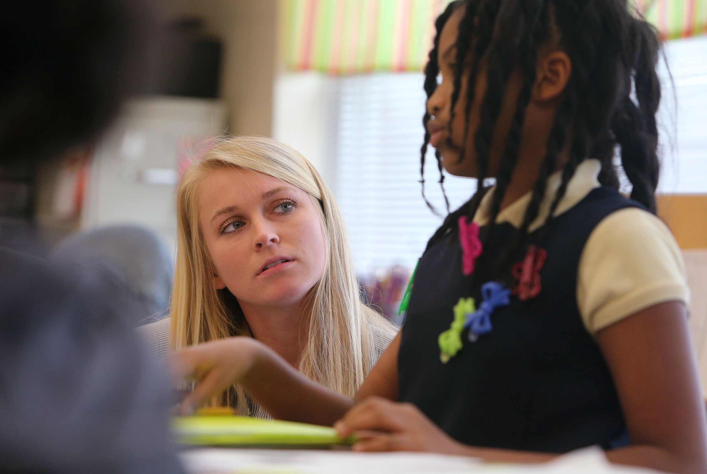 Christin Willingham, a student teacher from the University of Tennessee at Chattanooga, helps Zoey English, 8, in Wendy Scruggs' class at Battle Academy Wednesday, March 7, 2018 in Chattanooga, Tenn. UTC is changing how it prepares students to be teachers by expanding the length of time students spend as student teachers during their residency semesters.
