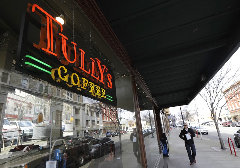 
              A man walks past an open Tully's Coffee store, Friday, March 9, 2018, in Tacoma, Wash. Other Tully's locations in the Seattle area have been temporarily closed, as a spokeswoman cites a rebranding effort and a lack of coffee. The company, founded in 1992, was purchased out of bankruptcy in 2013 by Michael J. Avenatti, better known today as the attorney for Stormy Daniels, the porn actresss who was paid $130,000 in 2016 to keep quiet about an alleged affair with Donald Trump a decade before he was elected president. (AP Photo/Ted S. Warren)
            