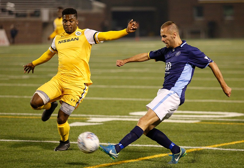 Chattanooga Football Club's Joao Costa, right, shoots around Nashville Soccer Club's Bradley Bourgeois during Saturday night's exhibition game at Finley Stadium. Nashville SC won 3-1.