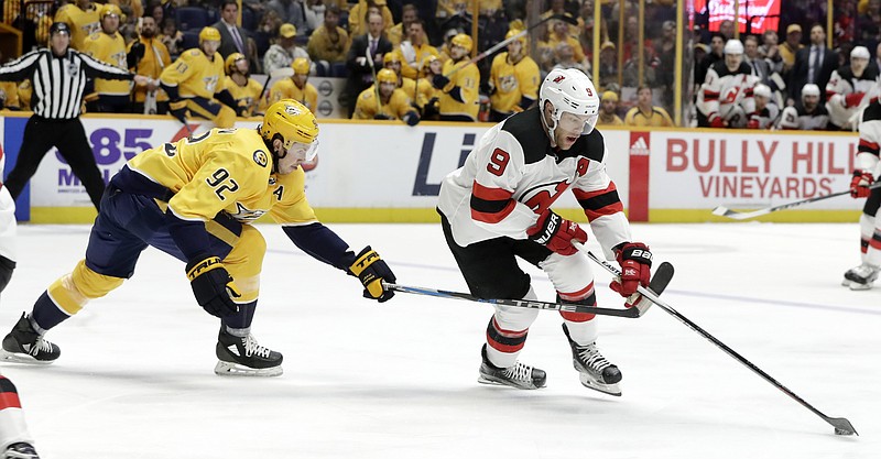 New Jersey Devils left wing Taylor Hall (9) tries to get past Nashville Predators' Ryan Johansen (92) in the first period of an NHL hockey game Saturday, March 10, 2018, in Nashville, Tenn. (AP Photo/Mark Humphrey)