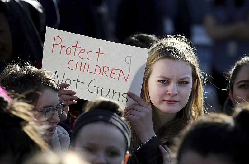 In this Feb. 28, 2018, photo, Somerville High School junior Megan Barnes marches with others during a student walkout at the school in Somerville, Mass. A large-scale, coordinated demonstration is planned for Wednesday, March 14, when organizers have called for a 17-minute school walkout nationwide to protest gun violence. (Craig F. Walker/The Boston Globe via AP)
